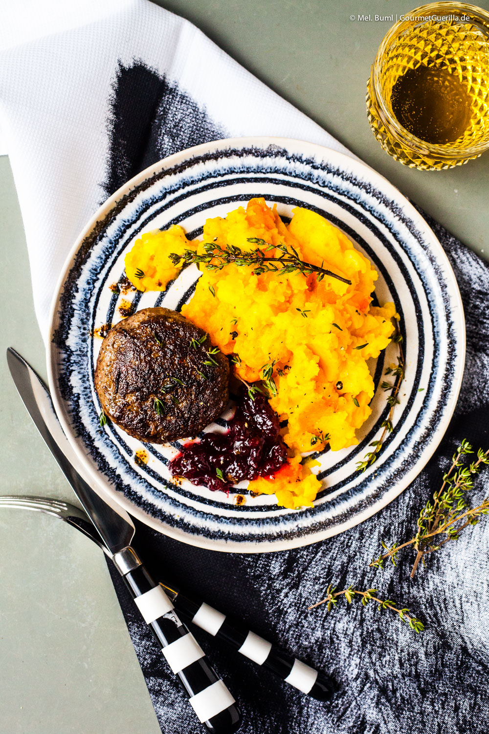 Homemade wild boar stew with pumpkin and potato mash and cranberries